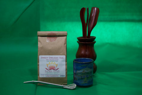 A loose leaf Sweet Dreams Tea blend in a compostable bag. Shown in a 2oz package, ready to ship. Shown with a tea cup, tea straw and tea accessorties
